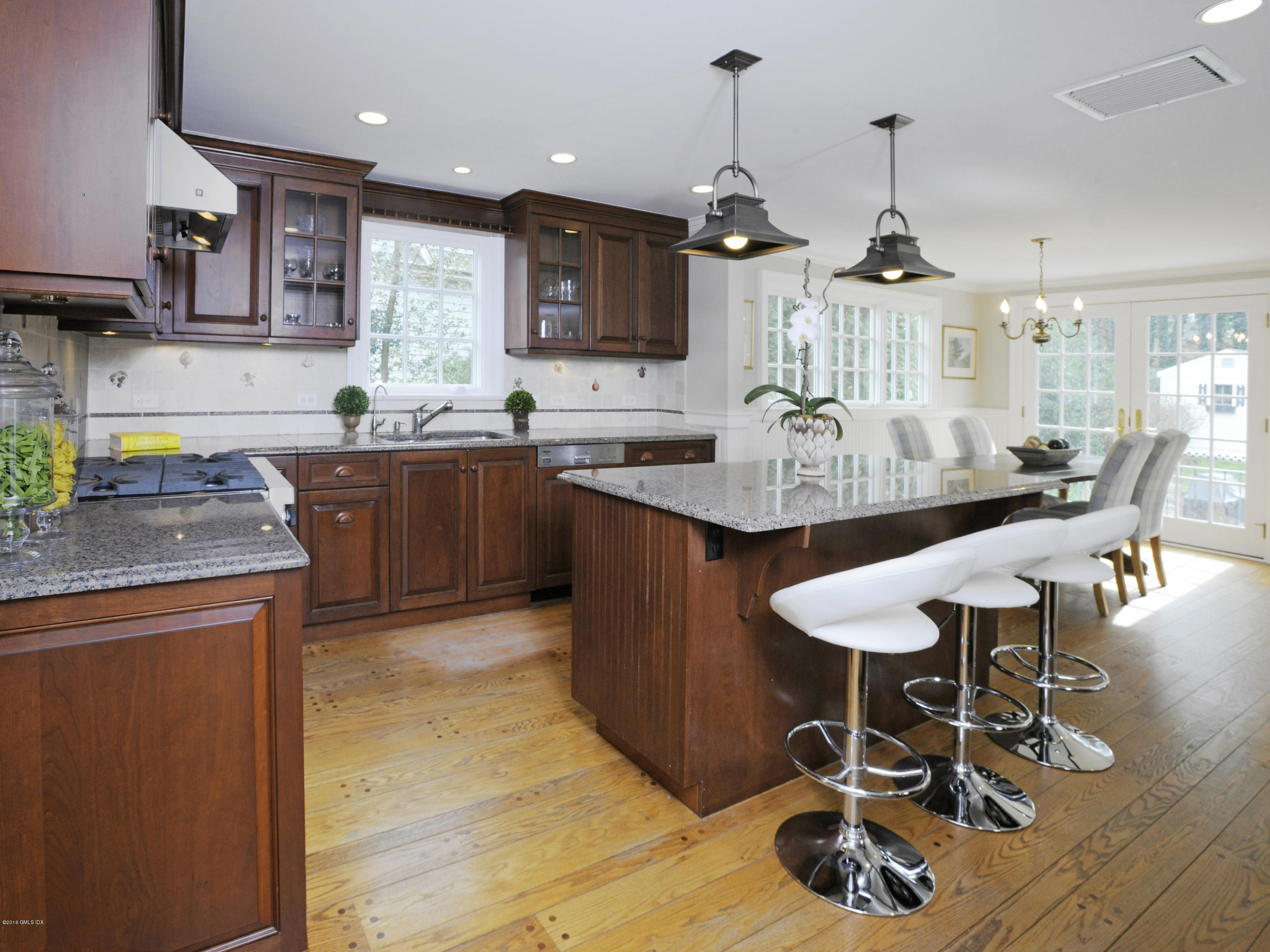 28 Lake Drive Riverside, CT 06878 - Photo 7 of 24 a kitchen with stainless steel appliances granite countertop a sink a stove and a wooden floors