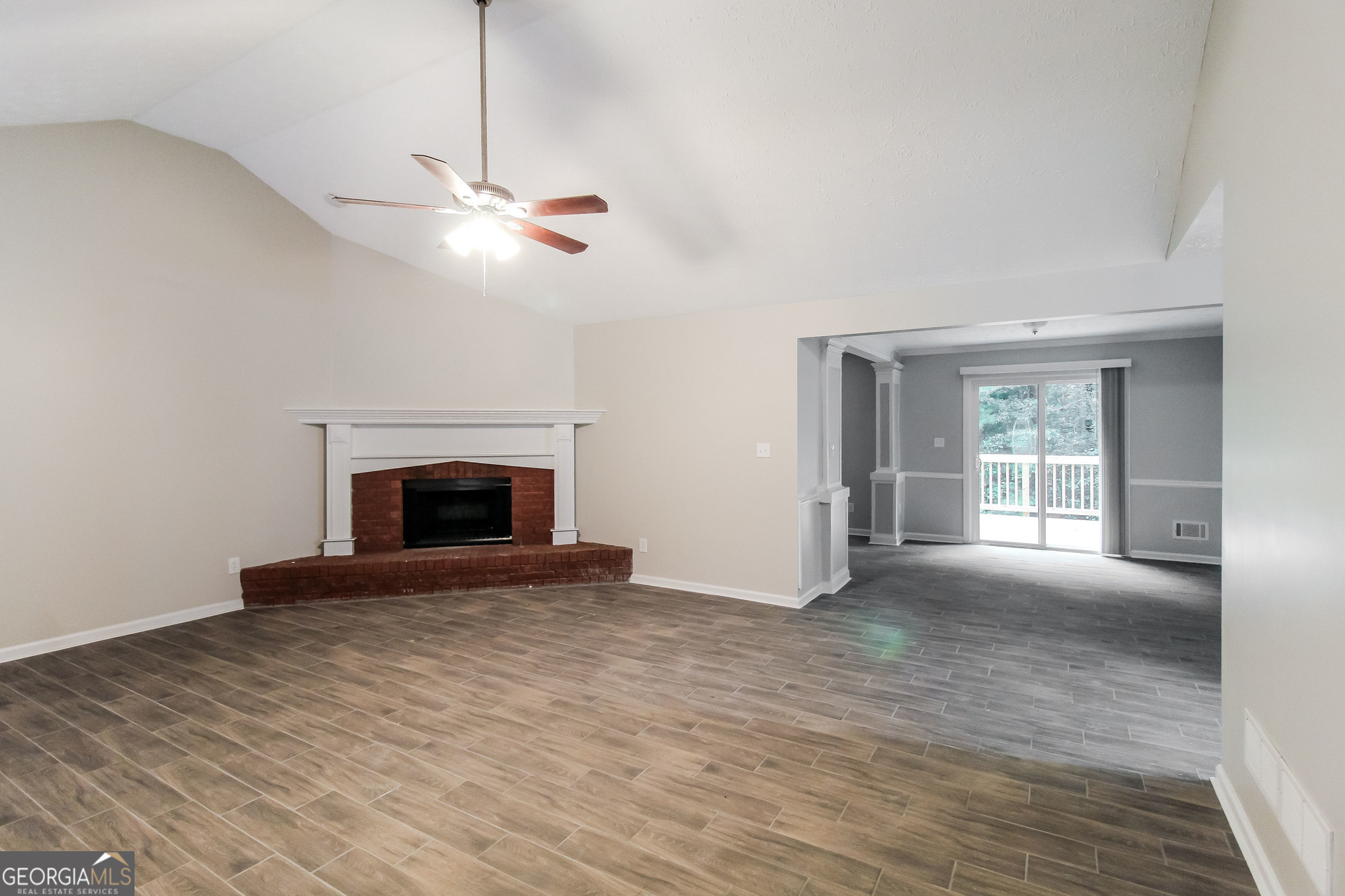 145 Cardell Farms Road Locust Grove, GA 30248 - Photo 3 of 17 a view of empty room with fireplace and fan