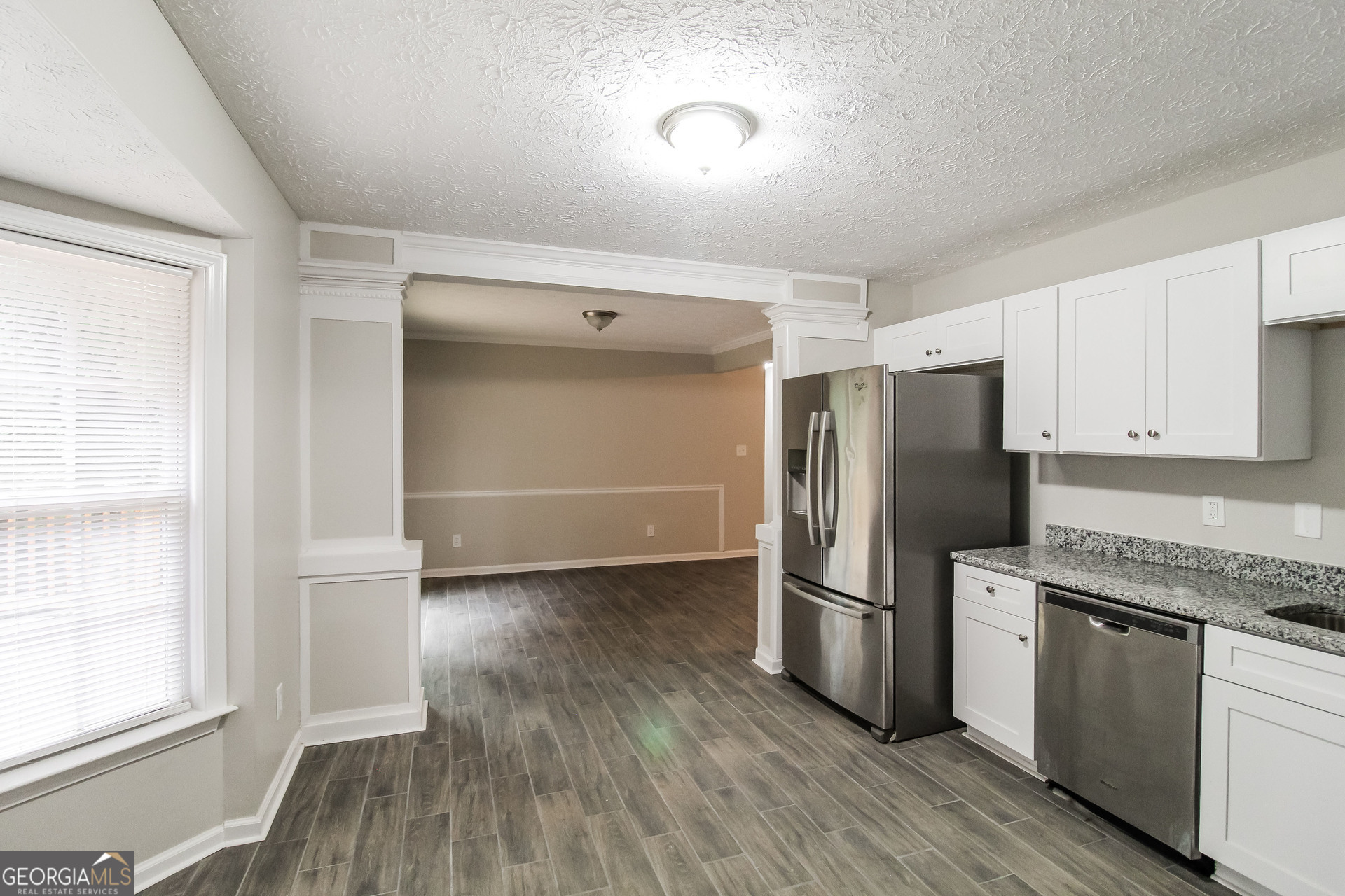 145 Cardell Farms Road Locust Grove, GA 30248 - Photo 6 of 17 a kitchen with stainless steel appliances granite countertop a refrigerator and a stove top oven