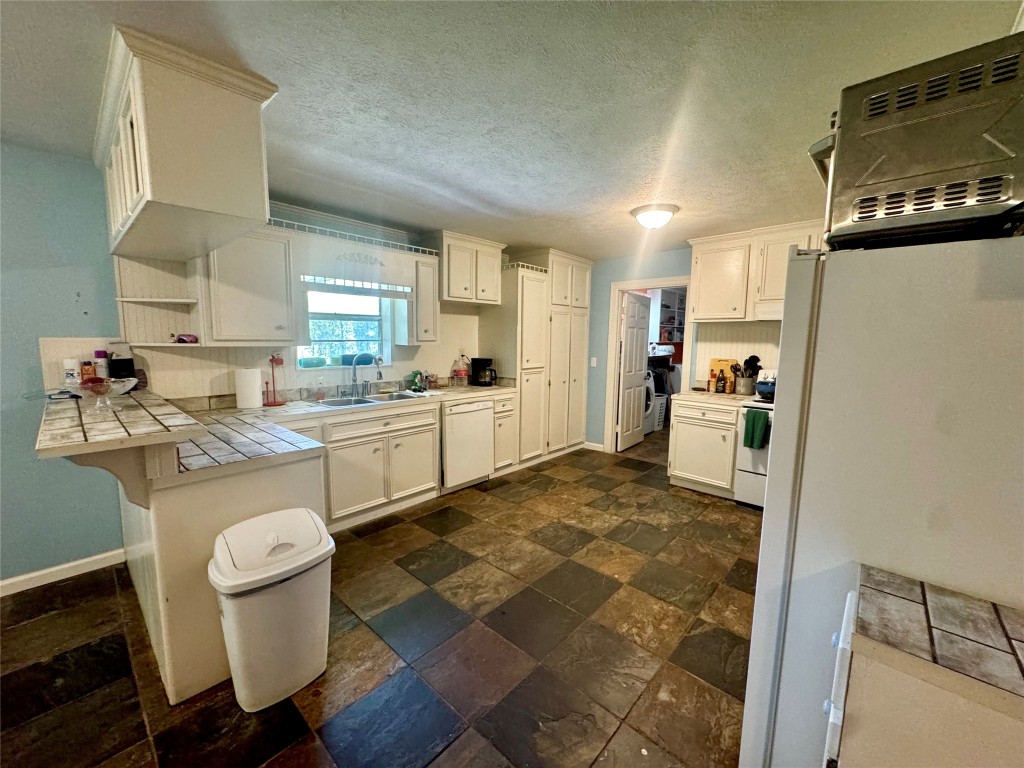303 Charles Street Cleveland, TX 77327 - Photo 20 of 43 a kitchen with a sink appliances and cabinets