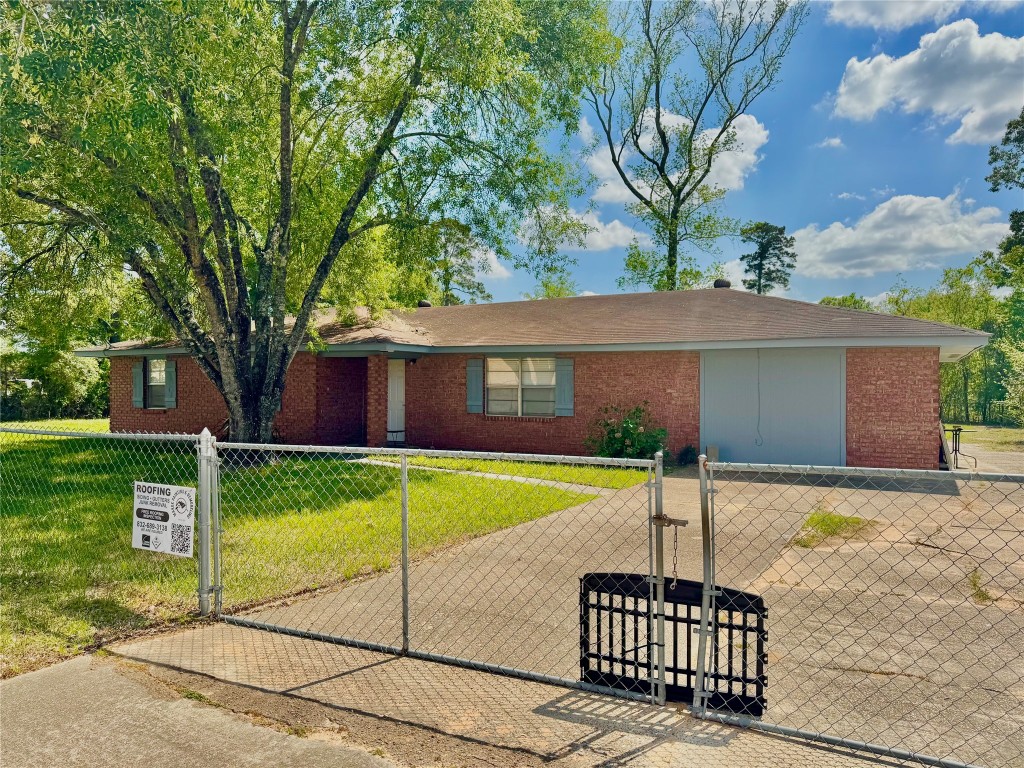 303 Charles Street Cleveland, TX 77327 - Photo 2 of 43 a front view of a house with garden