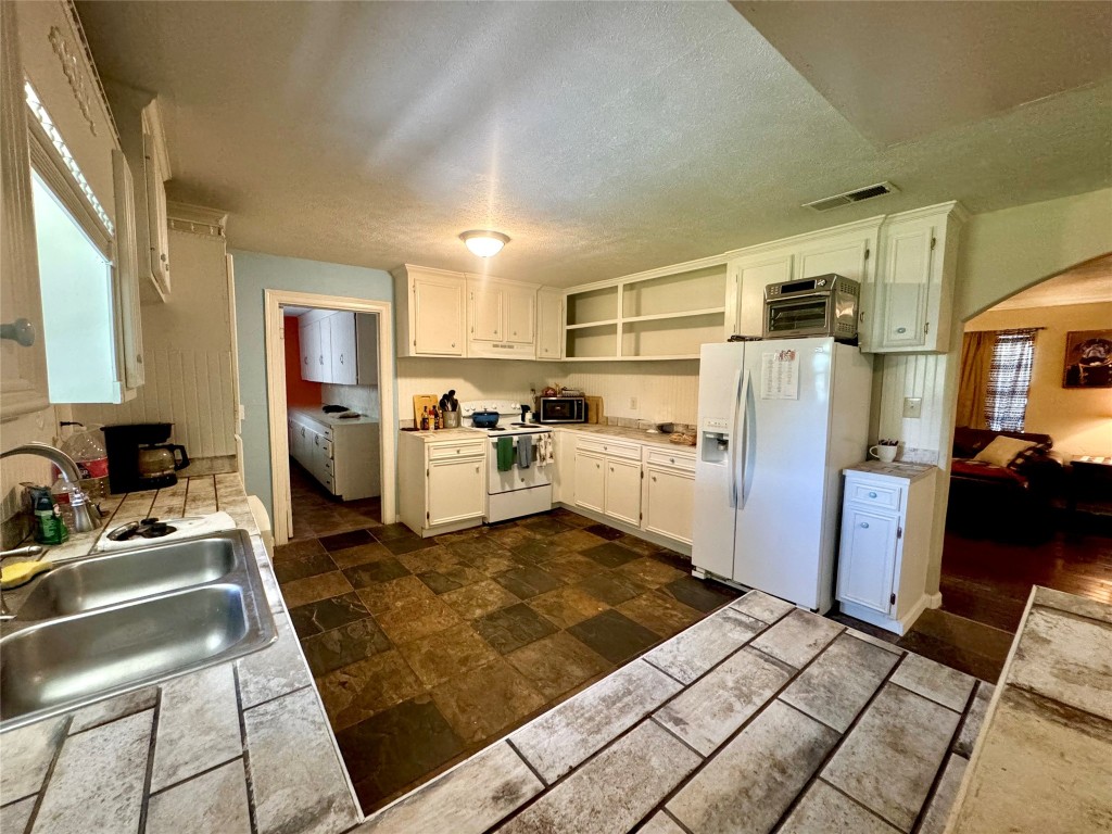 303 Charles Street Cleveland, TX 77327 - Photo 21 of 43 a kitchen with sink refrigerator and stove