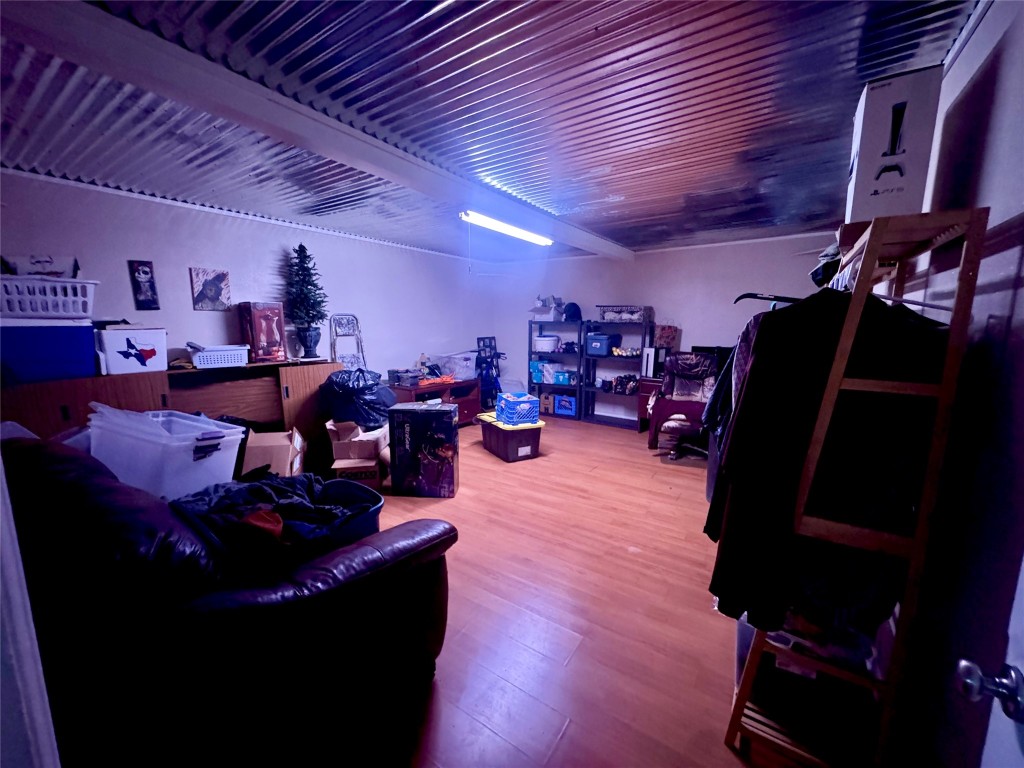 303 Charles Street Cleveland, TX 77327 - Photo 23 of 43 a living room with lots of furniture and clutter