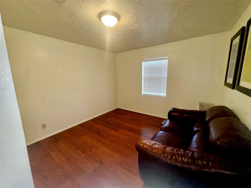 303 Charles Street Cleveland, TX 77327 - Photo 32 of 43 a bed sitting in a bedroom next to a window
