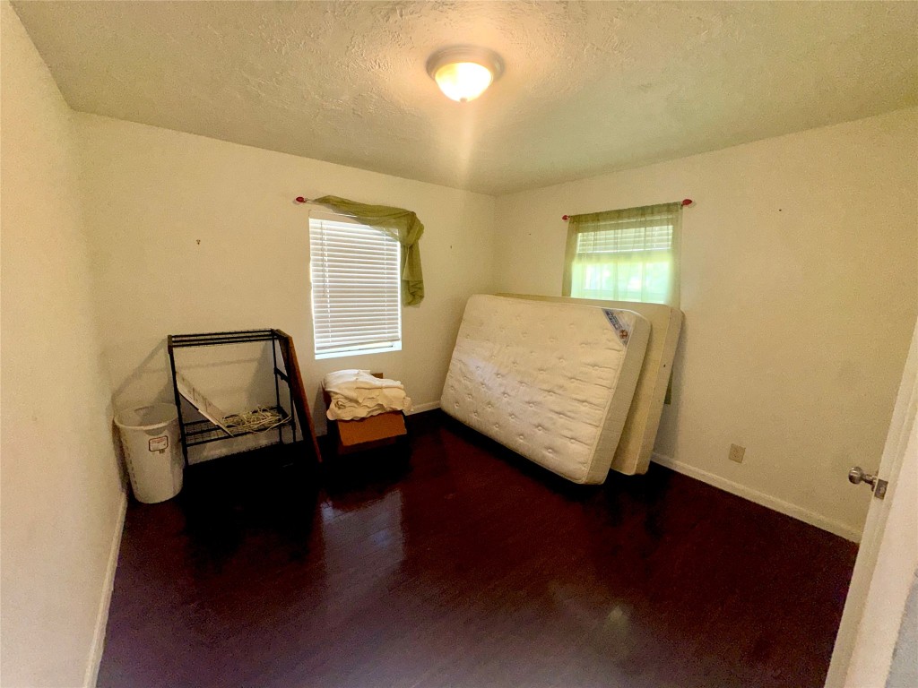 303 Charles Street Cleveland, TX 77327 - Photo 34 of 43 a room with two chairs and a lamp on a table