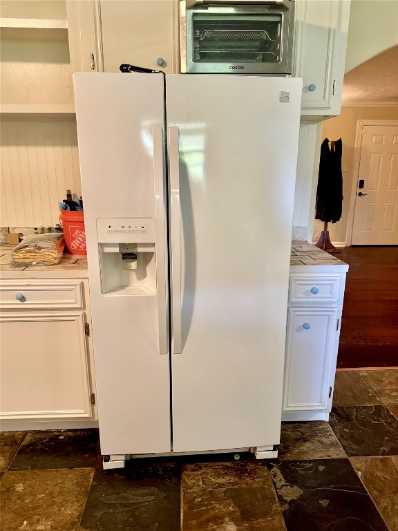 303 Charles Street Cleveland, TX 77327 - Photo 39 of 43 a white refrigerator freezer and a stove sitting inside of a kitchen