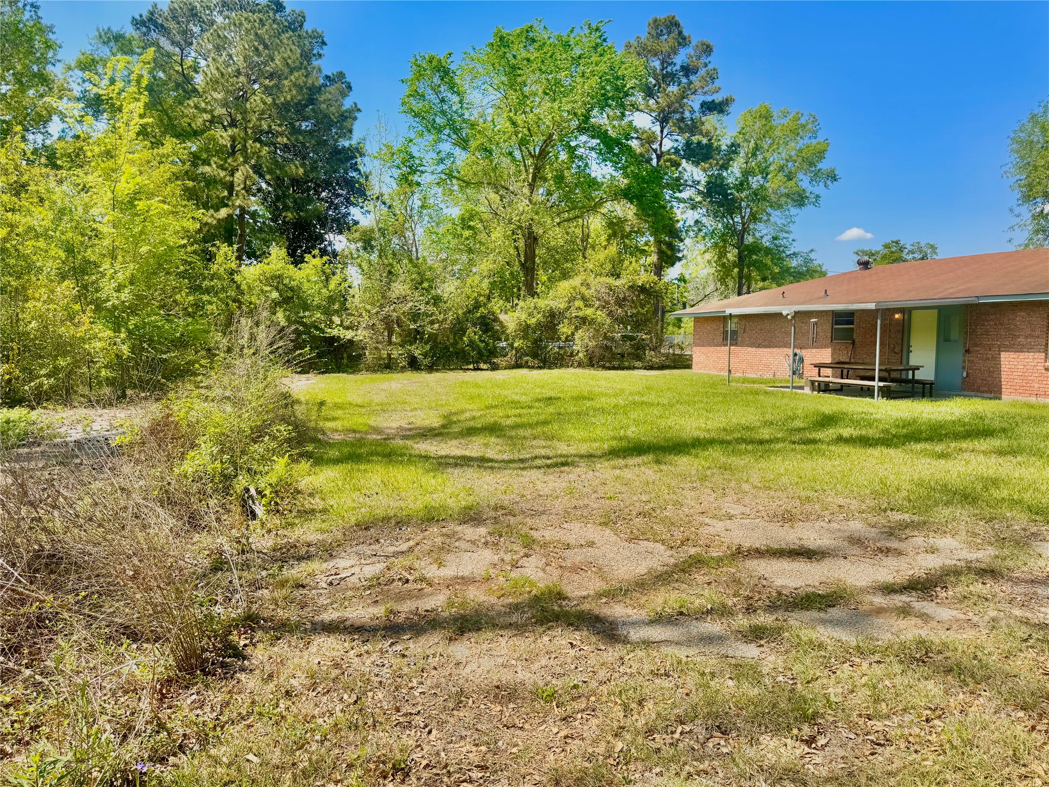 303 Charles Street Cleveland, TX 77327 - Photo 10 of 43 a front view of a house with a yard