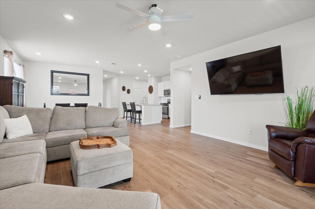 158 Gullivers Drive Elgin, TX 78621 - Photo 15 of 36 The open sightlines back to the kitchen are incredible. You can easily fit a huge sectional like this one without overcrowding the room at all.