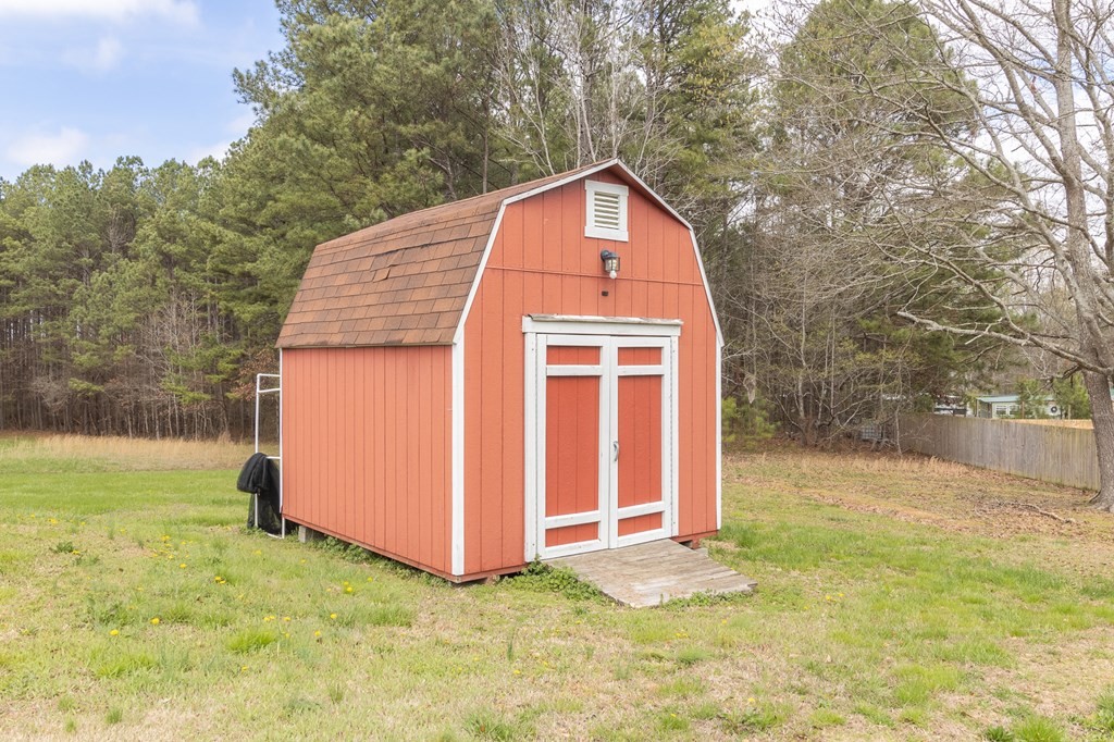 374 Allen Road West Chatsworth, GA 30705 - Photo 25 of 28 a view of a tiny house with yard and trees in the background