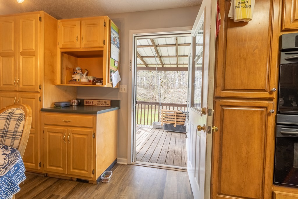 374 Allen Road West Chatsworth, GA 30705 - Photo 9 of 28 a view of a kitchen with wooden floor and a window