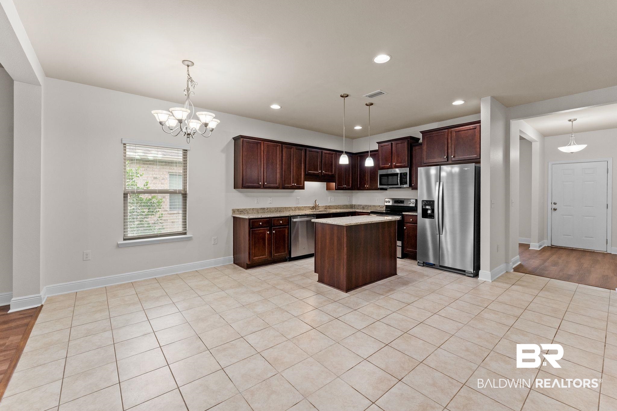 1464 Surrey Loop Foley, AL 36535 - Photo 14 of 24 Kitchen with stainless steel appliances, a kitchen island, dark brown cabinetry, recessed lighting, and decorative light fixtures