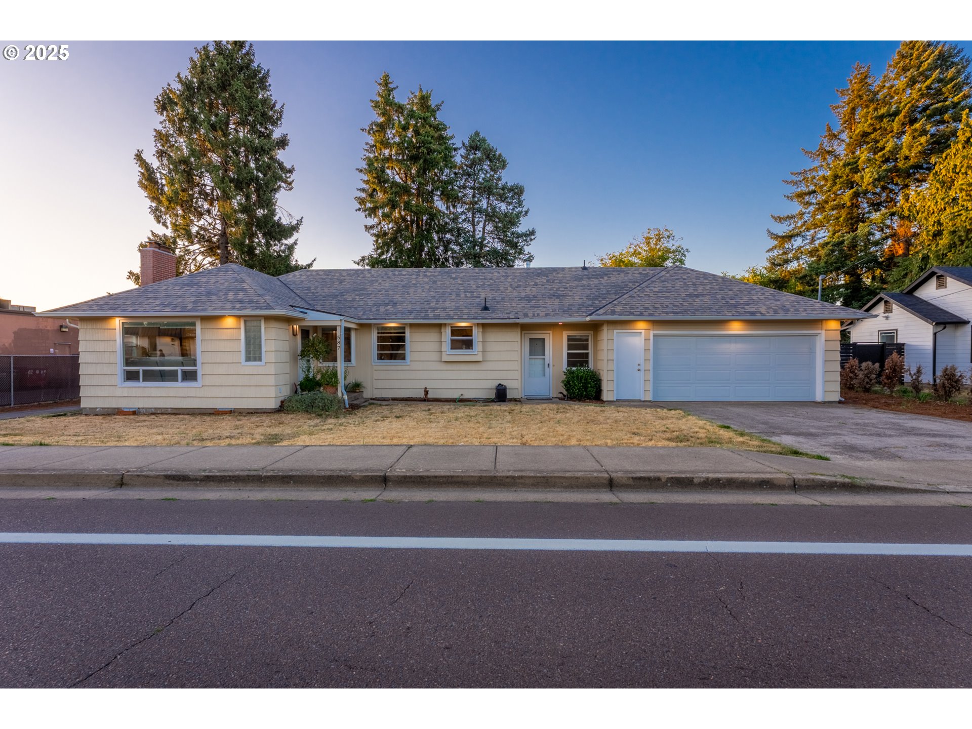 a front view of a house with a garden