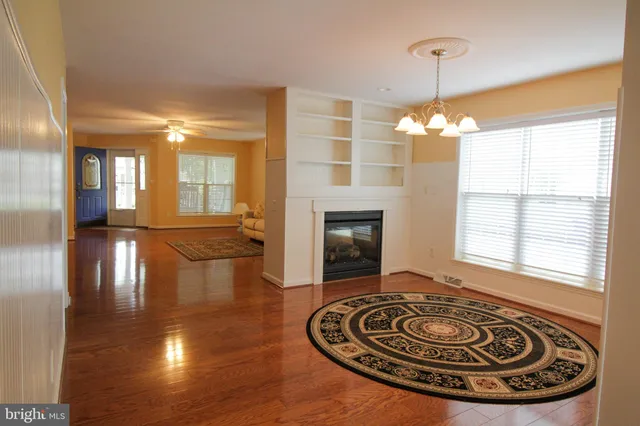 a view of a livingroom with furniture wooden floor and windows