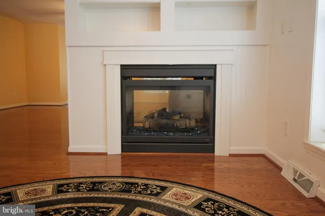 a open kitchen with granite countertop a stove top oven a sink dishwasher a refrigerator and cabinets with wooden floor