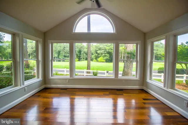 a kitchen with stainless steel appliances granite countertop a stove top oven a sink dishwasher a refrigerator and a microwave oven with large wooden cabinets