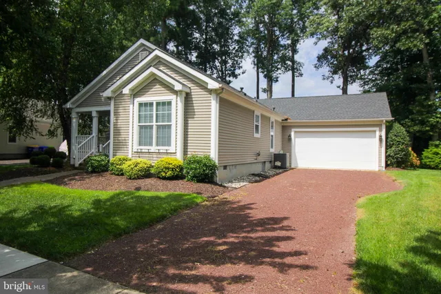 a view of a house with a big yard and a large tree