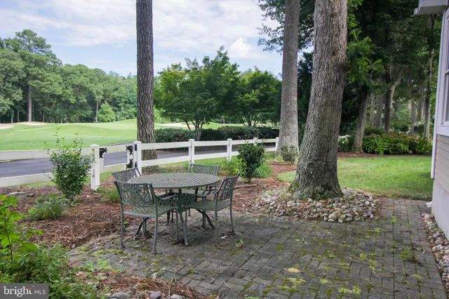 a view of a table and chairs in the garden