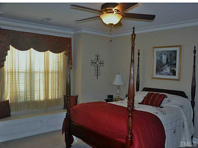 17 North Sunset Ridge Drive Willow Spring, NC 27592 - Photo 9 of 18 a bedroom with a bed and a chandelier