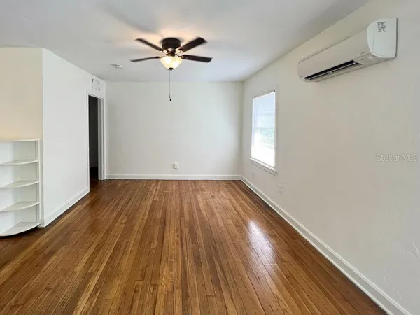 wooden floor in an empty room with a window