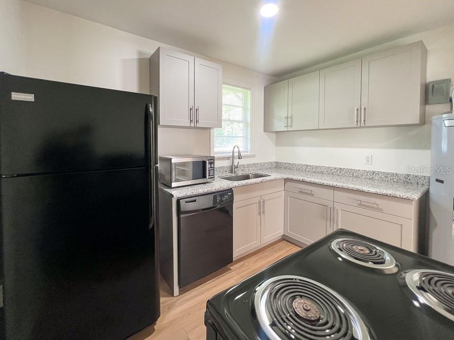 1124 Northwest 4th Avenue Gainesville, FL 32601 - Photo 6 of 16 a kitchen with a stove and a refrigerator