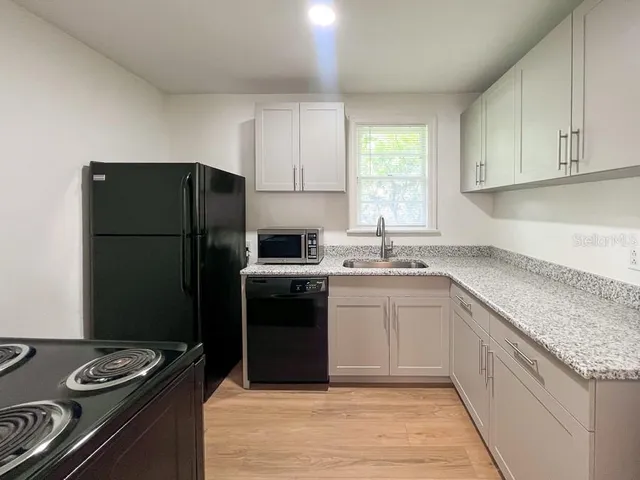 a kitchen with a refrigerator sink and stove