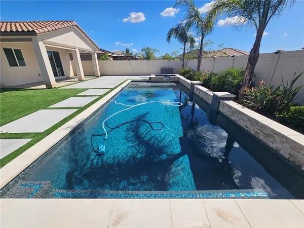 a swimming pool with outdoor seating and yard