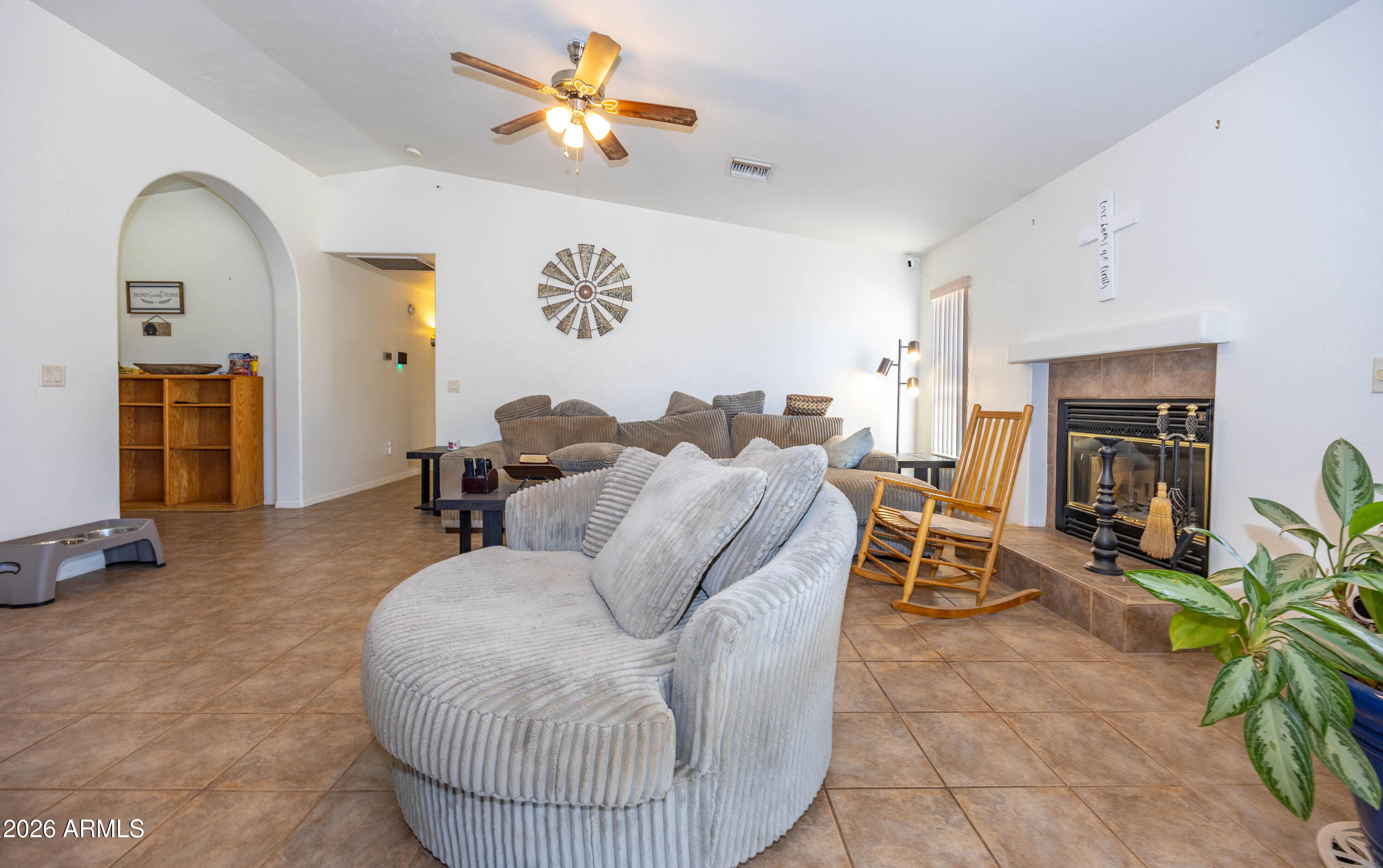 4575 South Kino Road Sierra Vista, AZ 85650 - Photo 14 of 25 a living room with furniture a fireplace and a flat screen tv