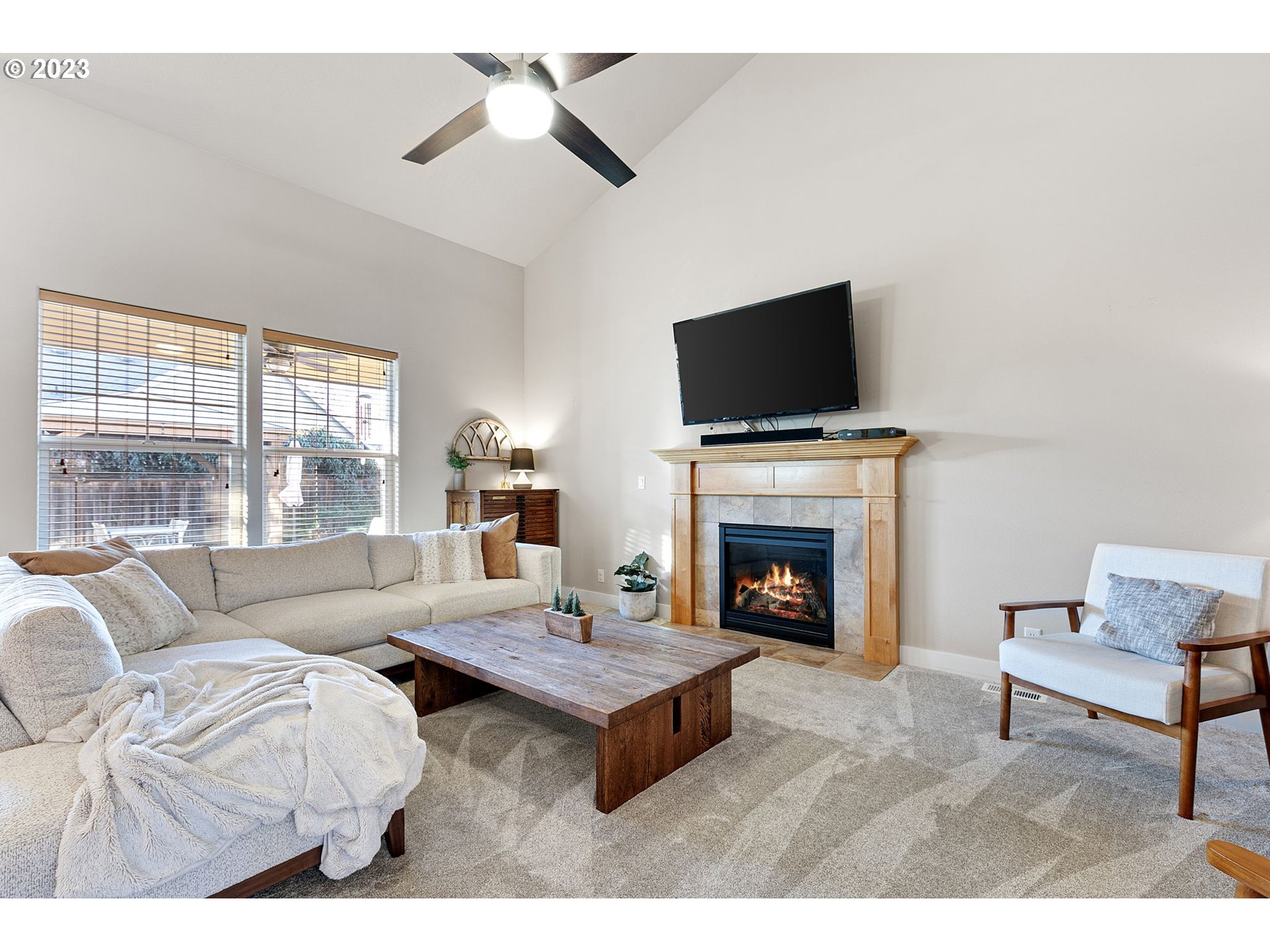 1200 South 41st Place Springfield, OR 97478 - Photo 16 of 34 a living room with furniture a fireplace and a flat screen tv