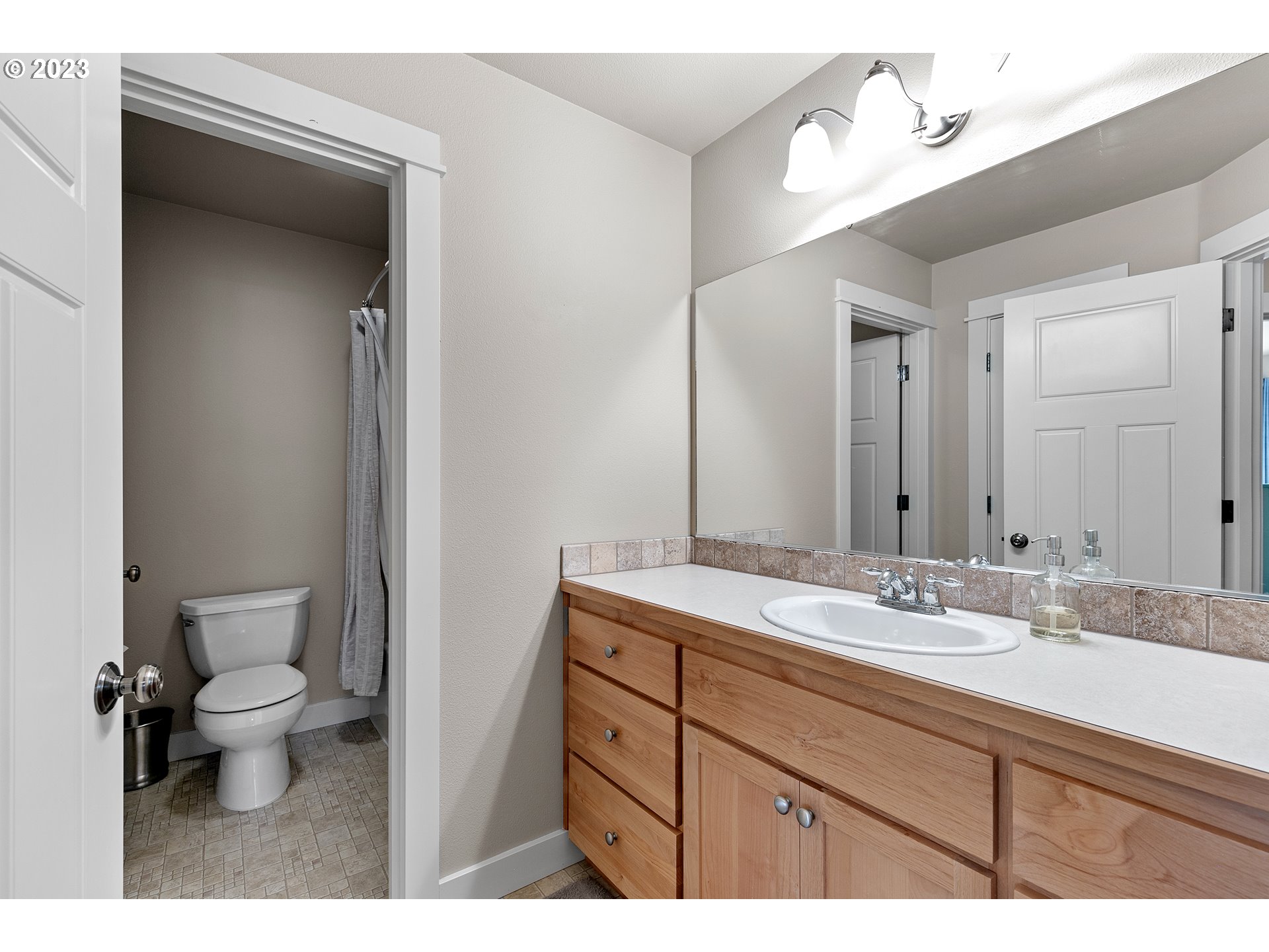 1200 South 41st Place Springfield, OR 97478 - Photo 26 of 34 a bathroom with a granite countertop sink and a mirror
