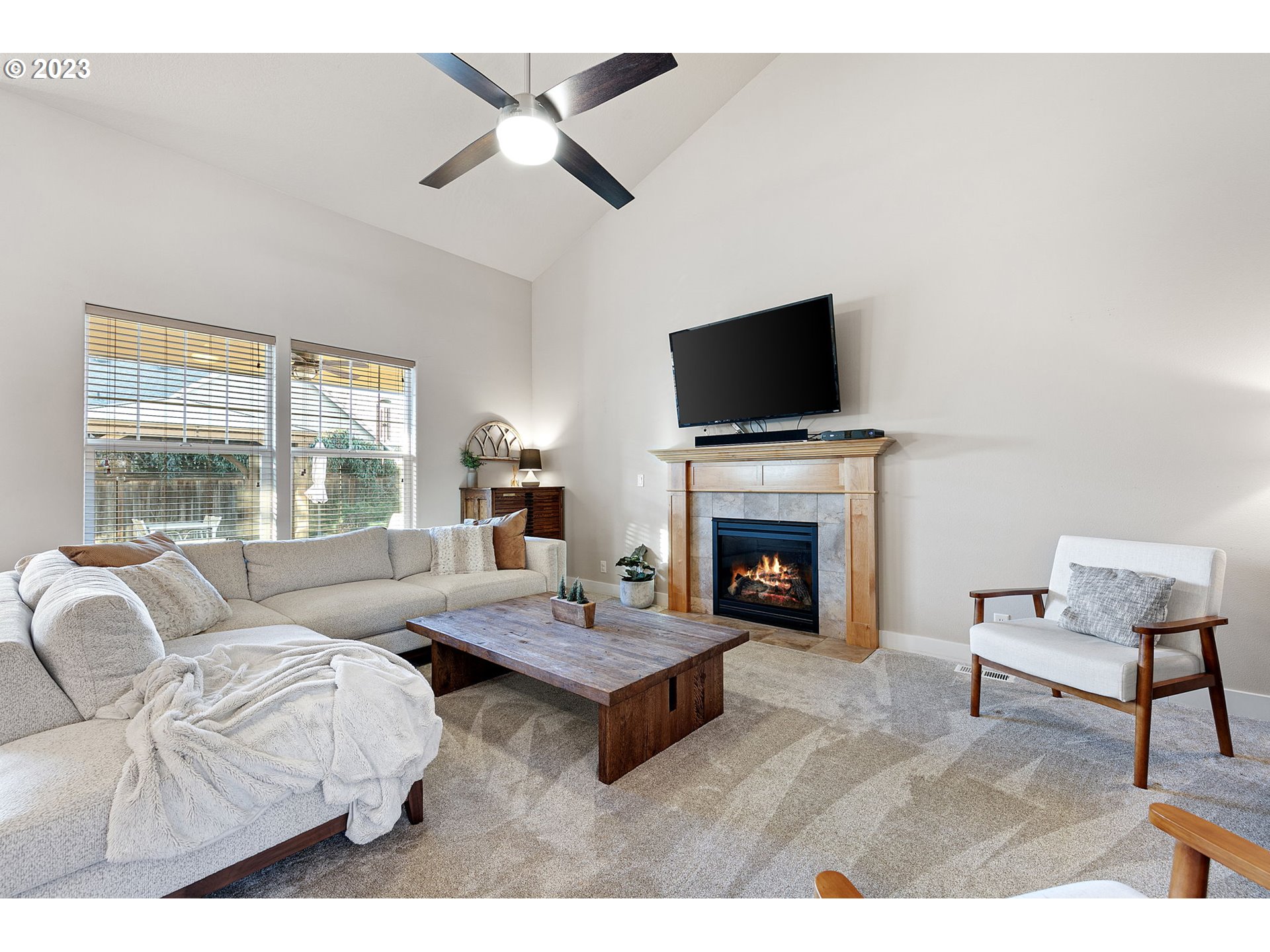 1200 South 41st Place Springfield, OR 97478 - Photo 10 of 34 a living room with furniture a fireplace and a flat screen tv