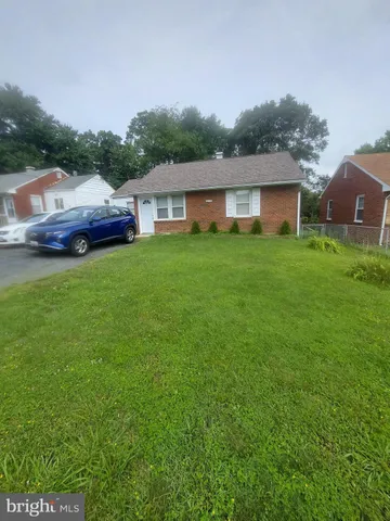 a front view of house with yard and trees