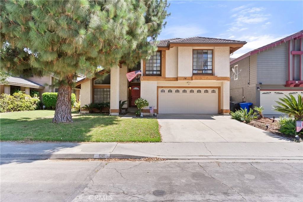 a front view of a house with a yard and a garage