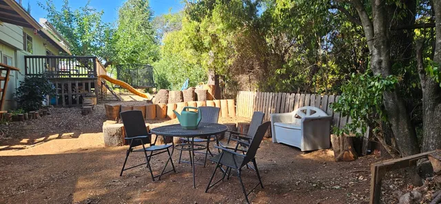 a view of a house with backyard and sitting area