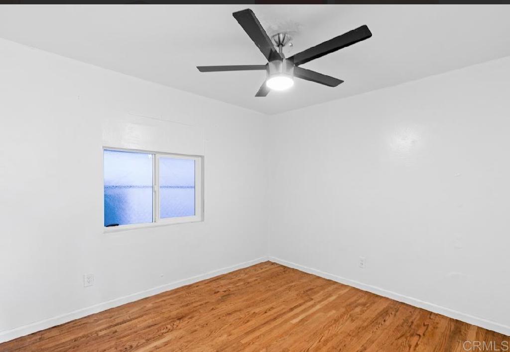 3964 Delta Street San Diego, CA 92113 - Photo 11 of 39 an empty room with wooden floor and windows