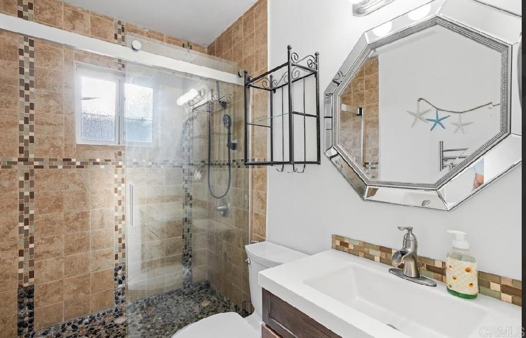 3964 Delta Street San Diego, CA 92113 - Photo 15 of 39 a bathroom with a sink a toilet and shower
