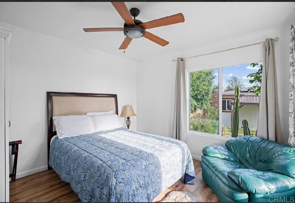 3964 Delta Street San Diego, CA 92113 - Photo 24 of 39 a bedroom with a bed couch and a window