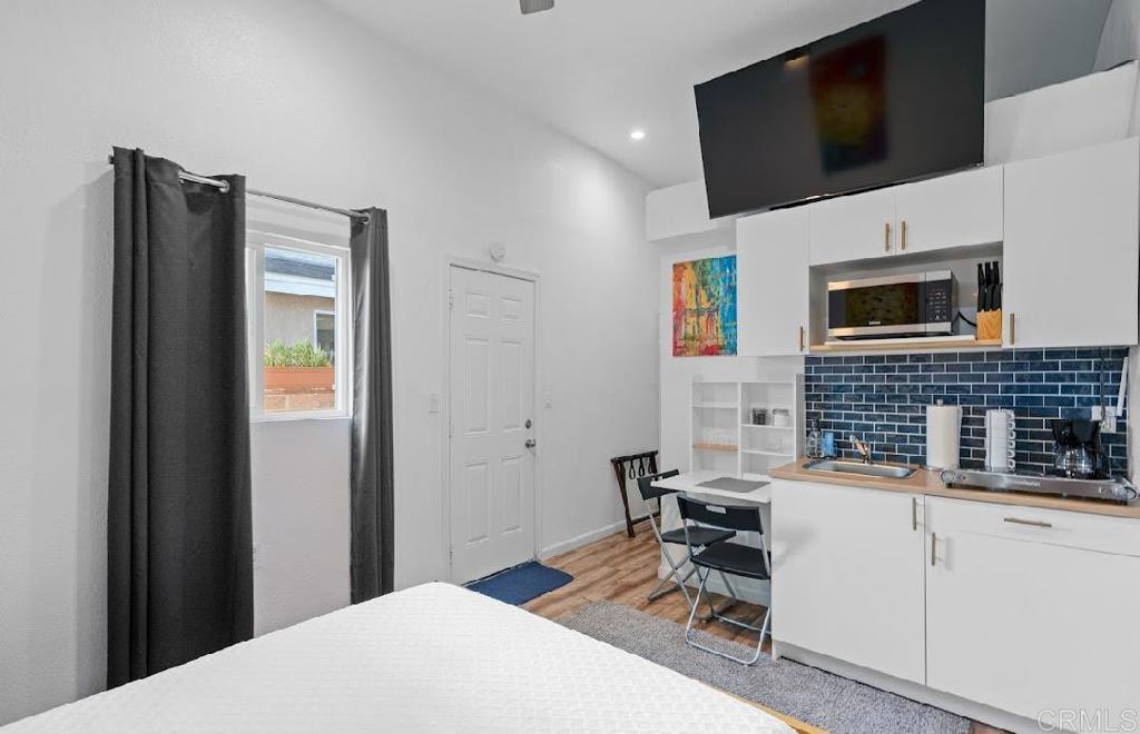 3964 Delta Street San Diego, CA 92113 - Photo 30 of 39 a bedroom with a bed and a flat screen tv