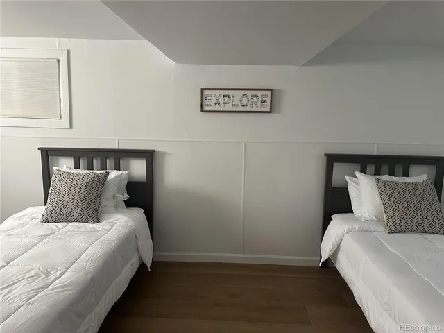 a bed sitting in a bedroom and lamp
