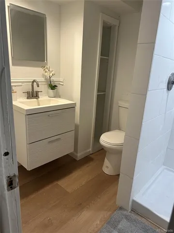 a bathroom with a sink toilet and a mirror