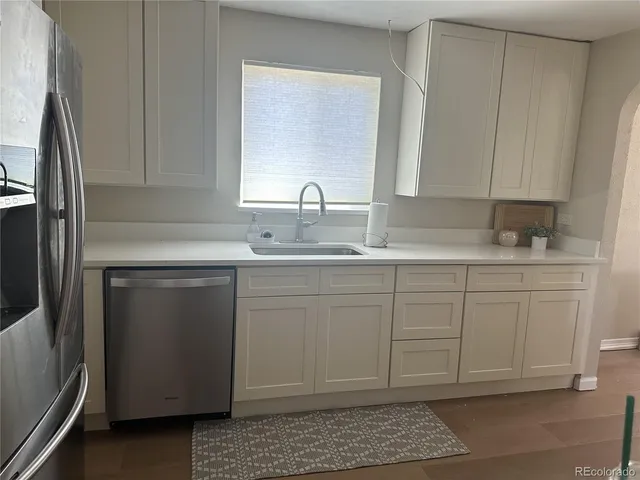 a kitchen with a sink cabinets and stainless steel appliances