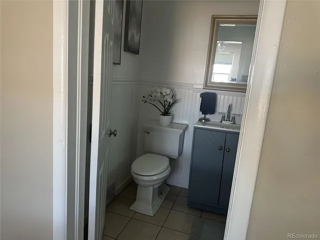 a bathroom with a sink toilet and a mirror