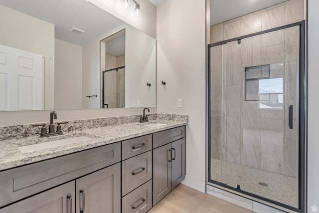 2535 West Santa Fe Drive Mapleton, UT 84664 - Photo 13 of 26 Bathroom featuring double vanity, a stall shower, and light wood-style flooring