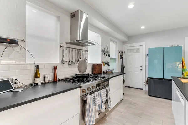 a kitchen with stainless steel appliances a sink a stove and a refrigerator
