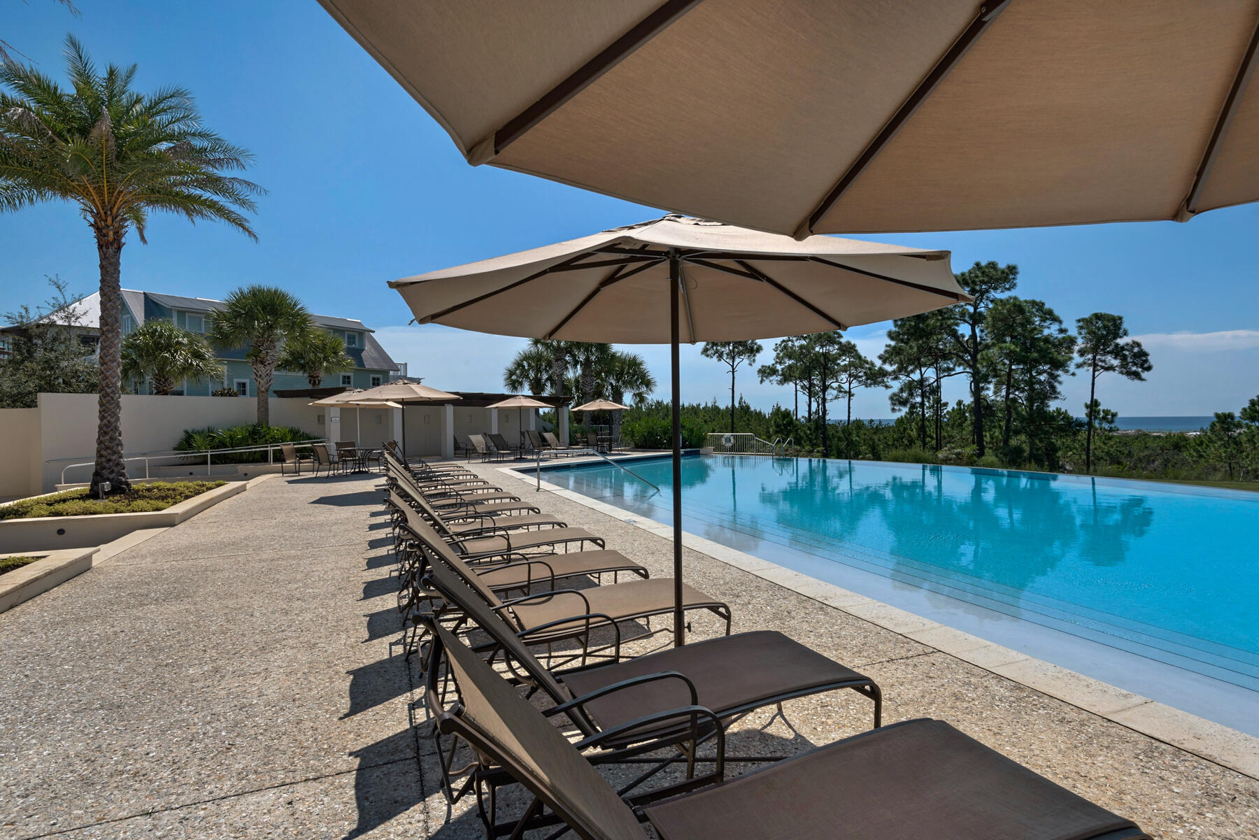 a view of a patio with chairs under an umbrella