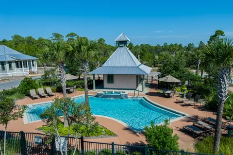 a swimming pool with yard outdoor seating and yard in back