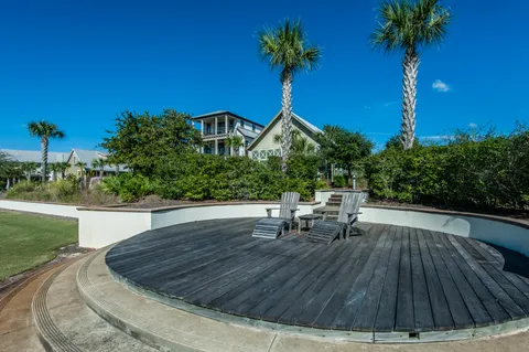 a view of a balcony with wooden floor and fence
