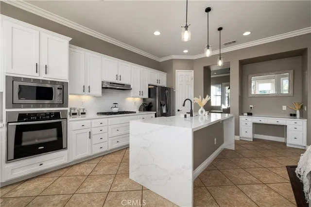 a kitchen with a stove a sink and a refrigerator