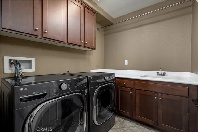 a utility room with sink dryer and washer