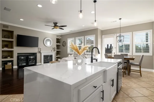a large kitchen with a table chairs and a fireplace