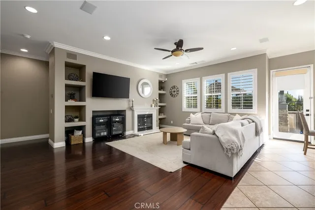 a living room with fireplace furniture and a flat screen tv